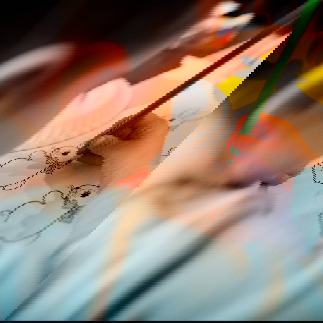 Little girl drawing and colouring a bunny.