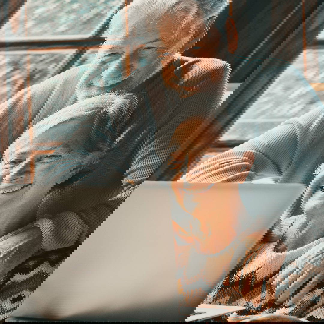 Old senior couple using a laptop.